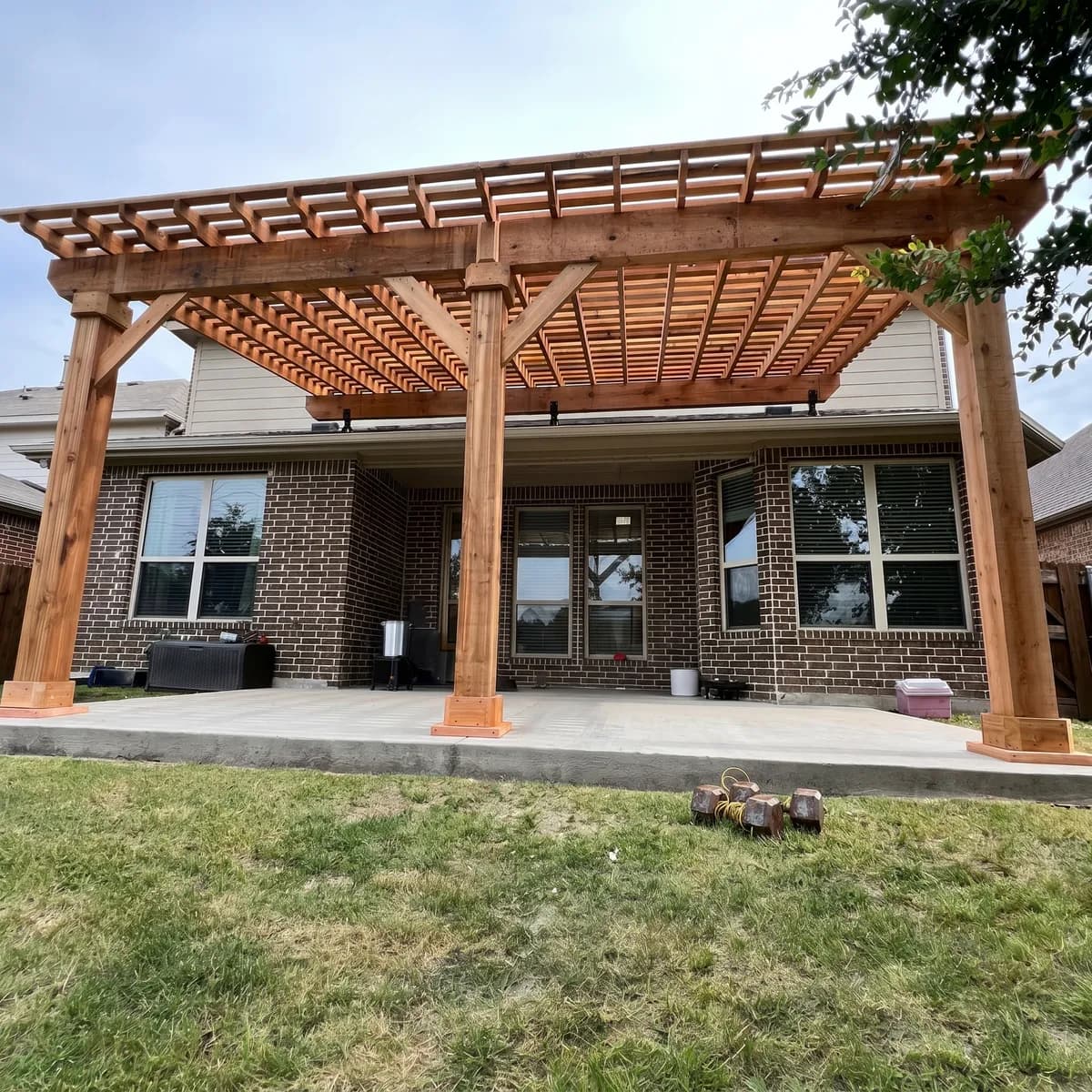 An attached cedar pergola built by Royal Patio extending a covered patio