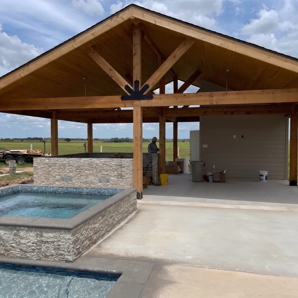 A large gabled cedar patio cover with tongue and groove ceiling built by Royal Patio over a spa