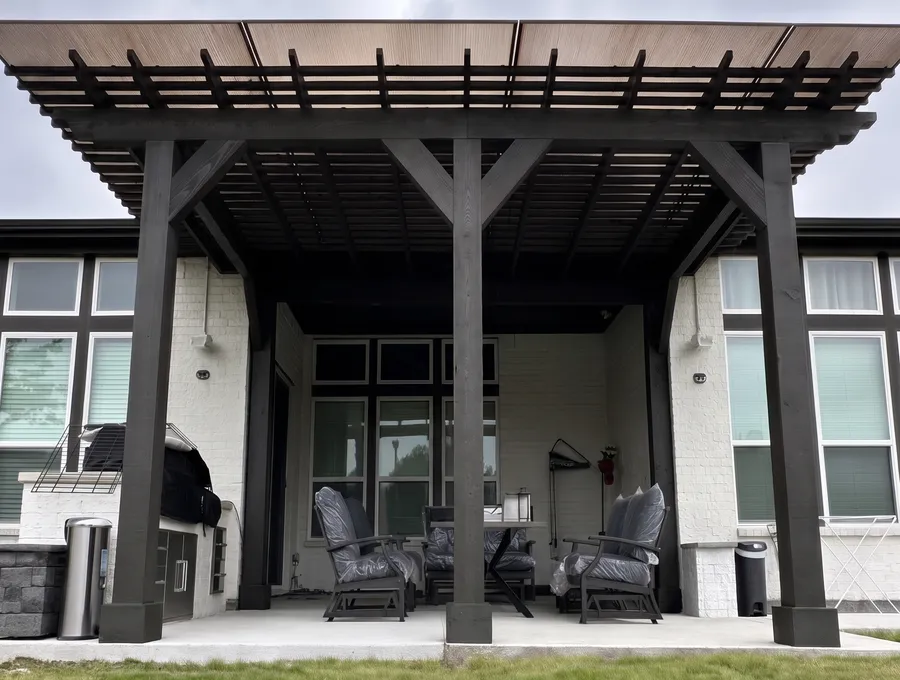 Dark-stained pergola over a furnished back patio