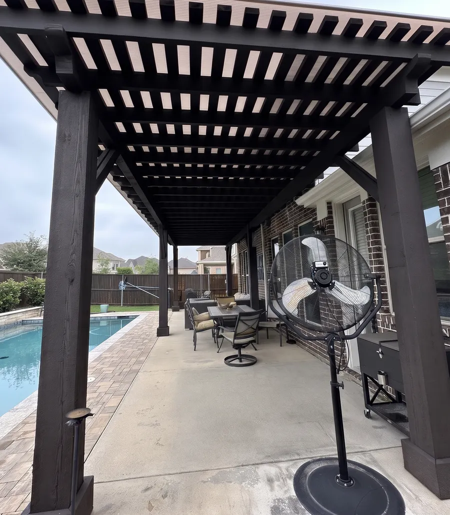 Dark-stained pergola shading a poolside seating area